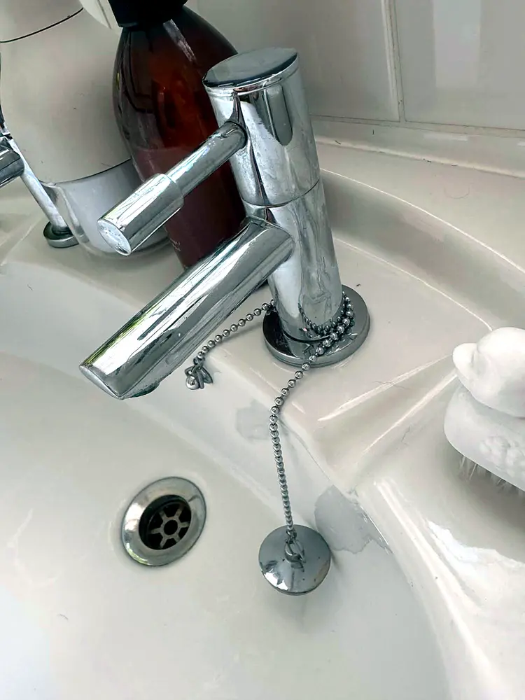 Bathroom tap dulled with water spots and limescale, before cleaning